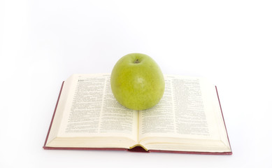 green apple and stack of book