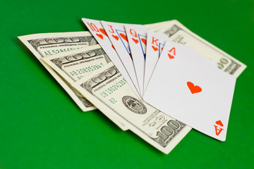 cards and money on a green cloth