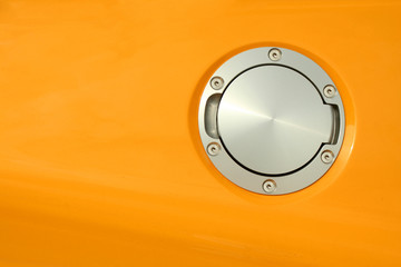 A Yellow sports car gas cap