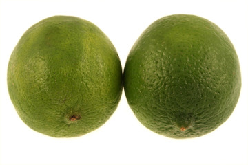 Two green limes isolated on a white background