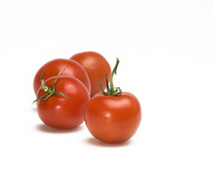 Studio shot of four fresh  tomatoes  against white background