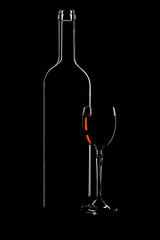 Bottle of wine and glass over a black background - 9627032