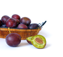 Basket with plum isolated on a white background