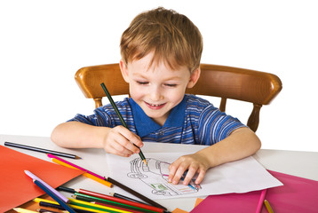 Young boy studies to draw