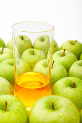 The glass with juice costs among set of green apples