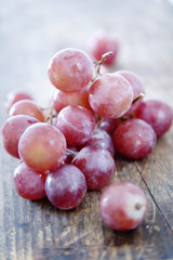 fresh red grapes on rustic wood