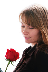 Beautiful young smiling woman with red rose