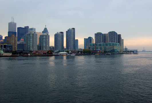 Toronto Skyline From Ontario Lake In Time Of Sunset.