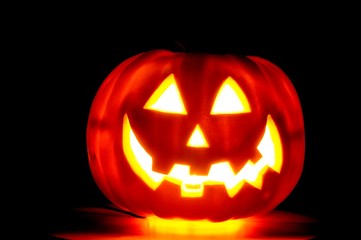 Glowing jack-o-latern isolated over a black background