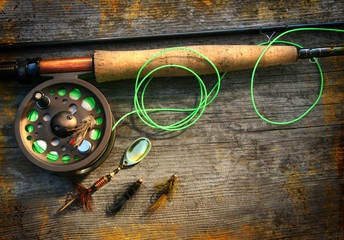 Fly fishing rod with polaroids pictures on wood background - 9644001