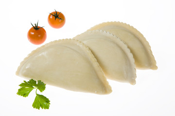 Asian meat dumplings with greenery and tomatoes