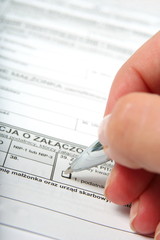 Filling in official form with pen