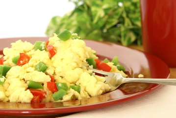 Fluffy scrambled eggs with red and green bell peppers
