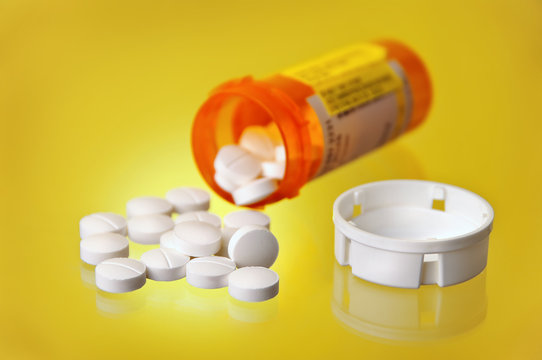Spilled Prescription Medication w/ Orange Pill Bottle On Yellow