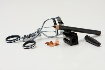Eye makeup supplies with pencil and sharpener and curler