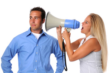 Young woman using megaphone to communicate to uninterested man
