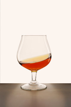 glass of brandy against white background