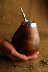 Hand holding traditional calabash for drinking mate