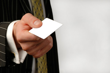 businessman holds  card in  hand, close up