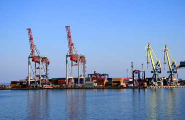 Mooring of trading port with cranes and cargo transporters