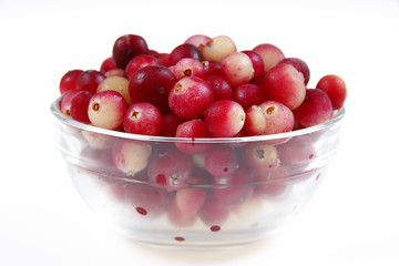 Naklejka na ściany i meble Close-up of fresh cranberry in glass dish on white background