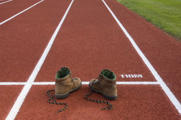 heavy hiking boots on running track - unsuitable equipment