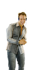 Naklejka premium Young male in casual outfit listening music