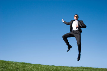 Businessman jumping in the air