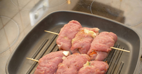 Meat dish with  added spices and vegetables on  frying pan