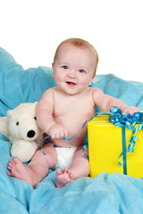 Happy baby opening a present sitting