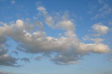 Cumulus white clouds in the dark blue sky