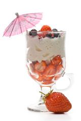 Strawberry with whipped cream in a glass on a white background