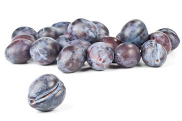 Fresh appetizing plums on a white background