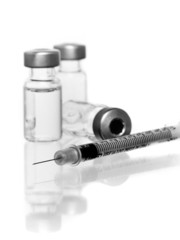 three vials with hypodermic needle