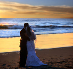 Couple wedding on the beach at sunset