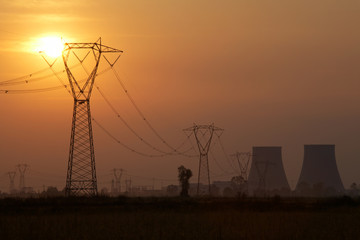 Power line of a nuclear power station; sunset.