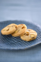 three homemade cookies on a blue ceramic plate