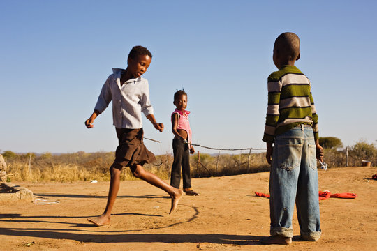 African Children Jumping Rope In The Sand,