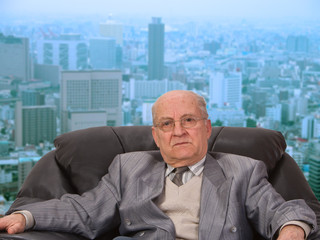 Portrait of an old businessman in front of the office window