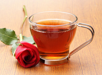 cup of tea with a red rose
