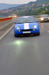 Obraz na płótnie Canvas cars speeding on highway captured with long exposure