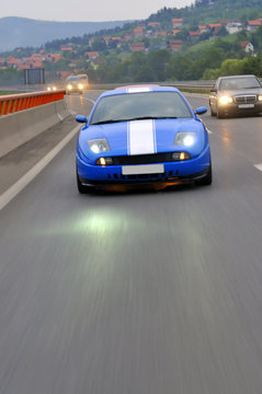 Fototapeta cars speeding on highway captured with long exposure