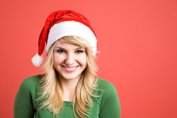 A portrait of a beautiful caucasian girl wearing santa hat