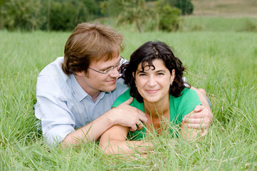 Young couple on a farmers meadow.