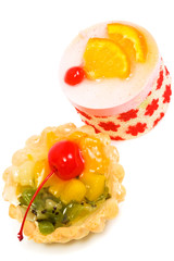 Sweet cakes with fruit on a white background