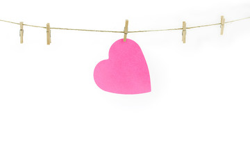 Pink paper heart on a clothes line.