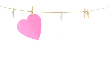 Pink paper heart on a clothes line.