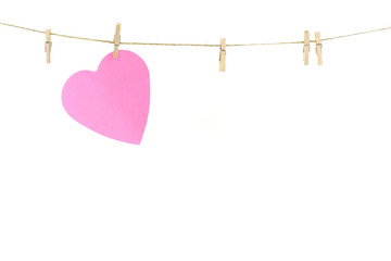 Pink paper heart on a clothes line.