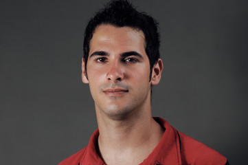 Headshot portrait of handsome serious young man