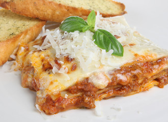 Lasagne with grated parmesan and garlic bread